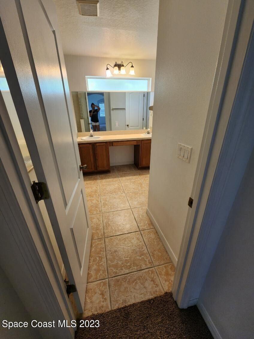 2004 Gloria Circle Palm Bay, FL 32905 - Photo 18 of 54 a view of a hallway and a livingroom with furniture