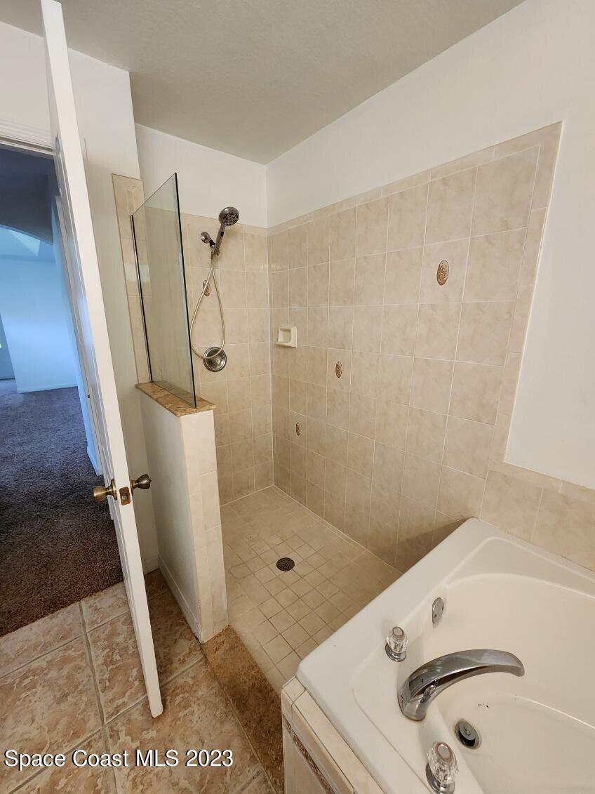 2004 Gloria Circle Palm Bay, FL 32905 - Photo 19 of 54 a bathroom with a sink a toilet and a shower