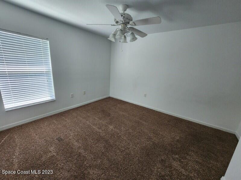 2004 Gloria Circle Palm Bay, FL 32905 - Photo 24 of 54 an empty room with a window and a ceiling fan