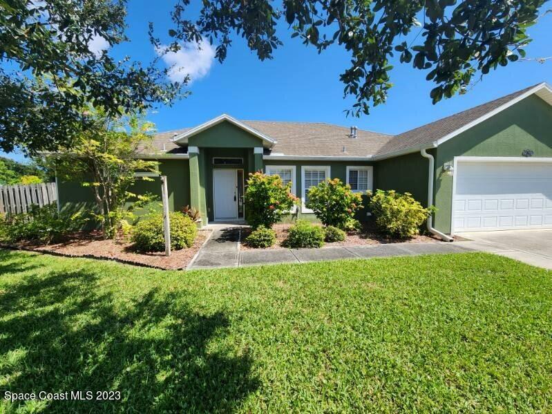2004 Gloria Circle Palm Bay, FL 32905 - Photo 3 of 54 a front view of a house with a yard