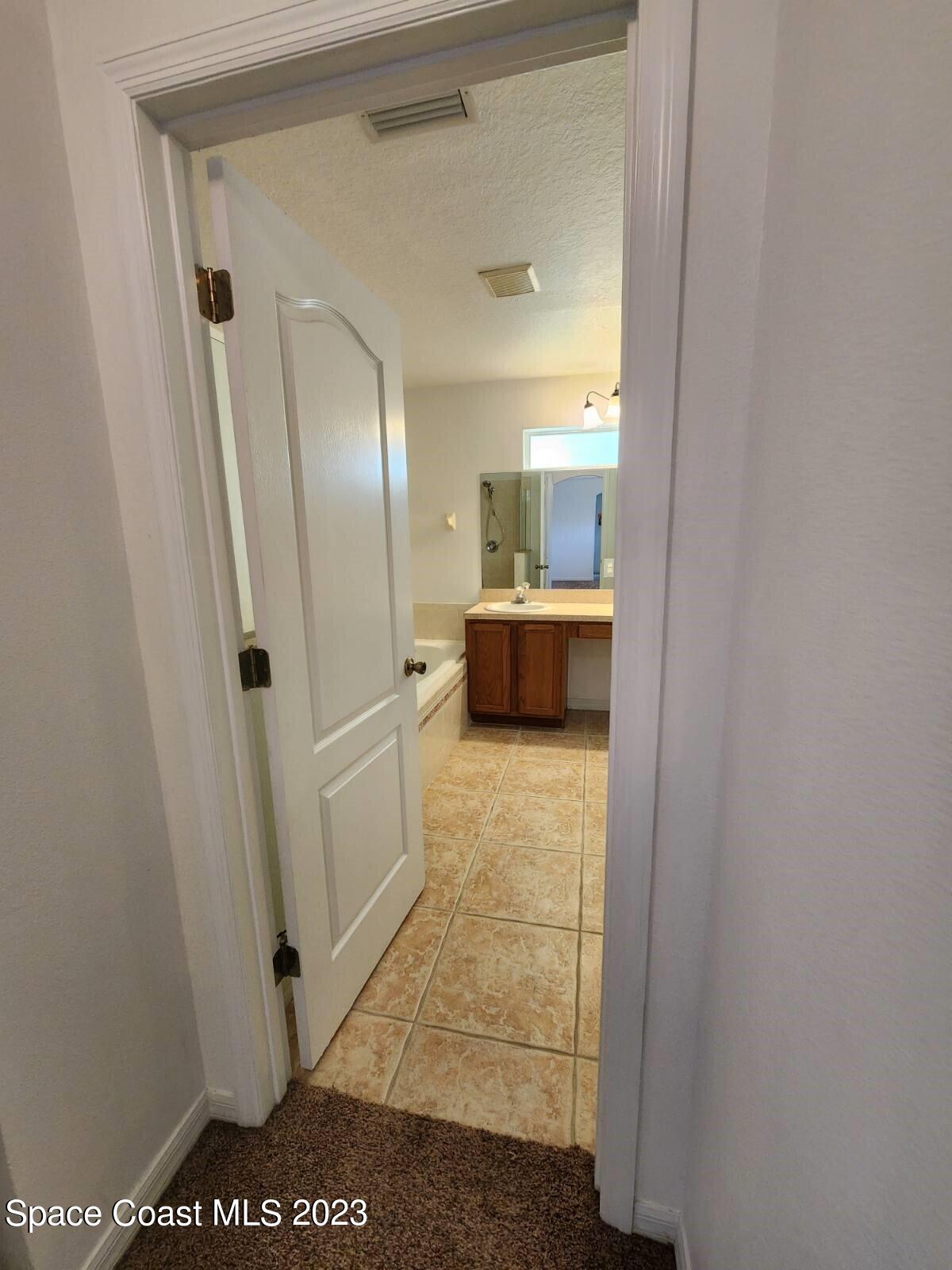 2004 Gloria Circle Palm Bay, FL 32905 - Photo 33 of 54 a view of a hallway to rooms