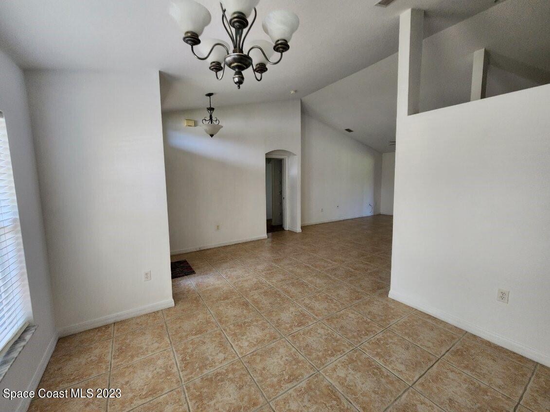 2004 Gloria Circle Palm Bay, FL 32905 - Photo 35 of 54 a view of a hallway with a chandelier