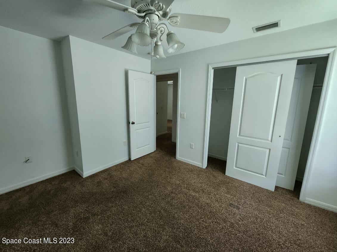 2004 Gloria Circle Palm Bay, FL 32905 - Photo 39 of 54 an empty room with closet and a chandelier fan
