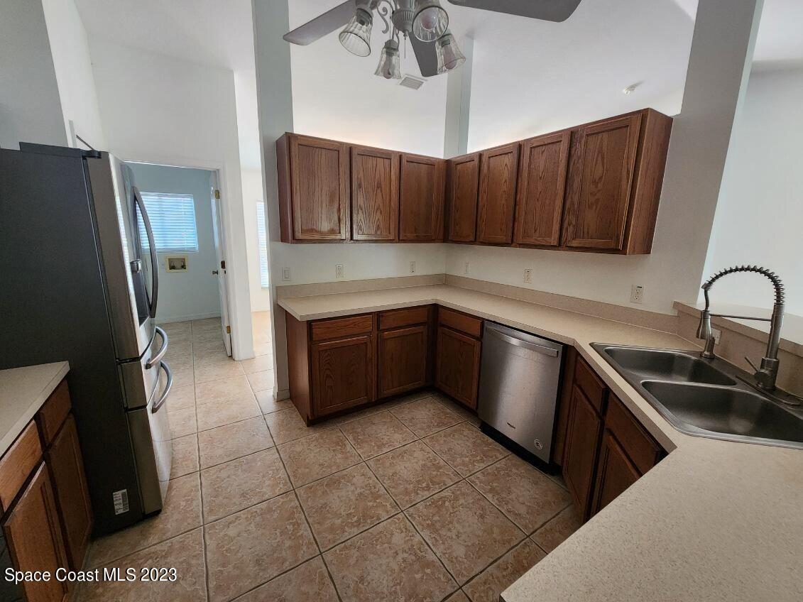 2004 Gloria Circle Palm Bay, FL 32905 - Photo 5 of 54 a kitchen with stainless steel appliances a sink a stove a refrigerator and cabinets