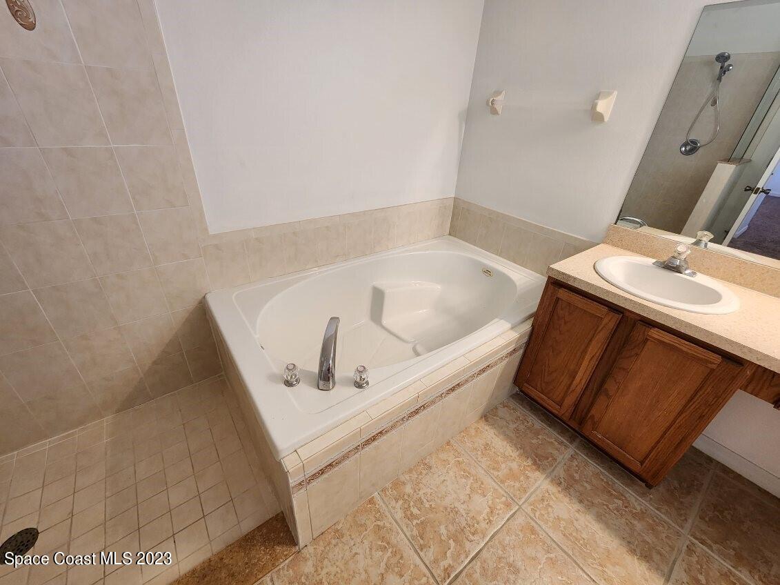 2004 Gloria Circle Palm Bay, FL 32905 - Photo 9 of 54 a bathroom with a tub sink and mirror