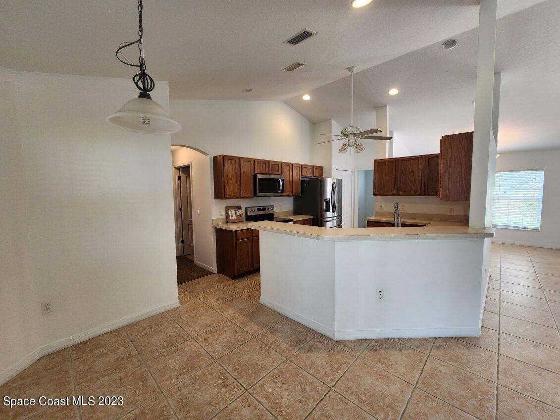 2004 Gloria Circle Palm Bay, FL 32905 - Photo 10 of 54 a large kitchen with a large counter top appliances and cabinets