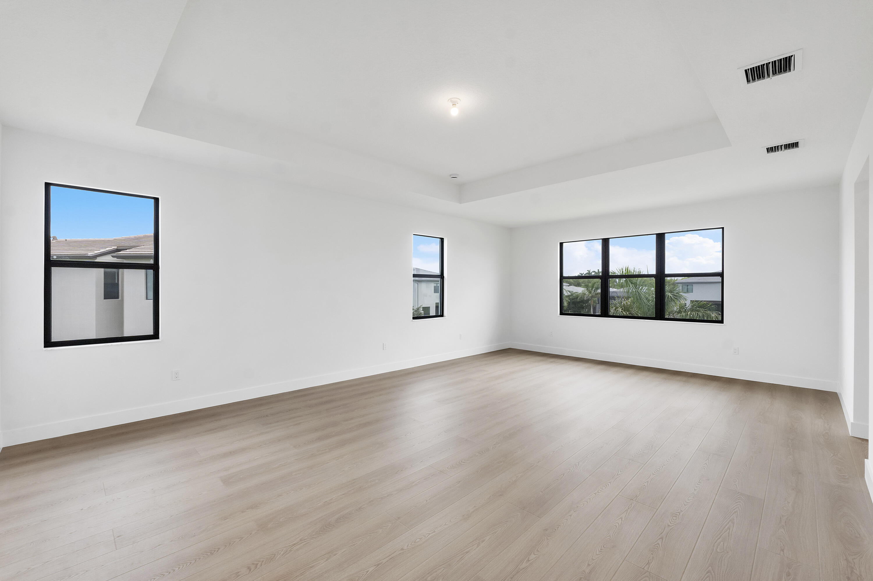 9322 Sunflower Mdw Road Boca Raton, FL 33434 - Photo 30 of 87 a view of an empty room with a window and wooden floor