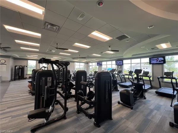 a view of a room with gym equipment and a projector screen