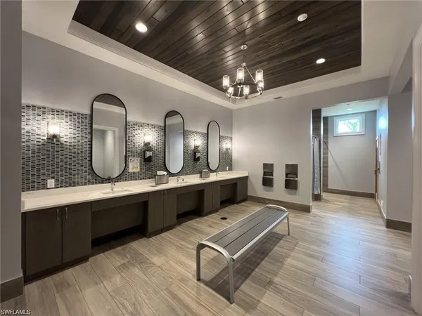 a large bathroom with double vanity sinks a vanity two mirror and a bathtub