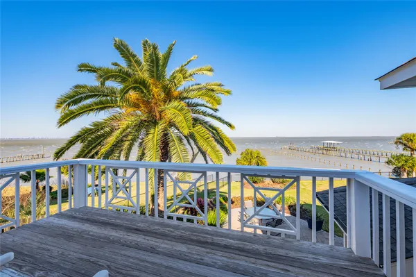 a view of swimming pool with outdoor seating and plants
