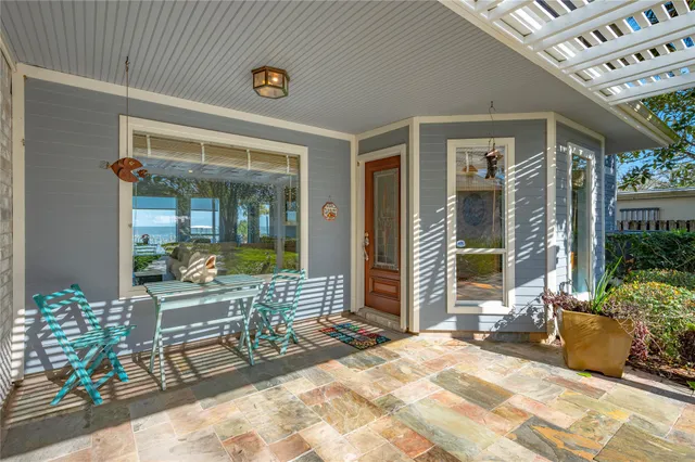 a view of a patio with table and chairs and potted plants