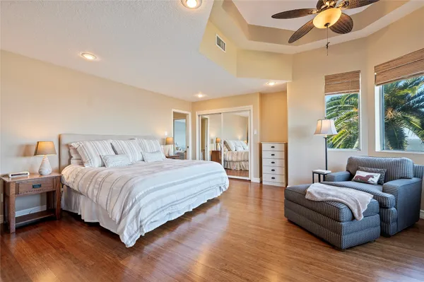 a spacious bedroom with a bed and large windows