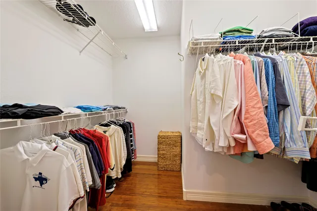 a view of walk in closet with clothes and shoes