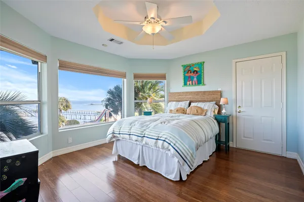 a bedroom with a large bed and a large window