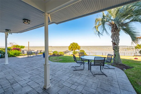 a view of a patio with a table and chairs