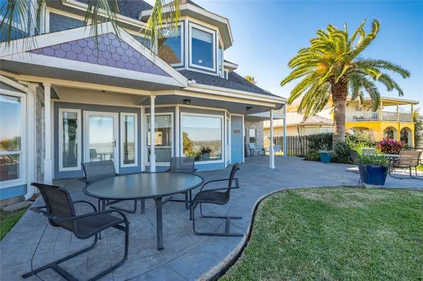 a view of a house with a swimming pool and sitting area