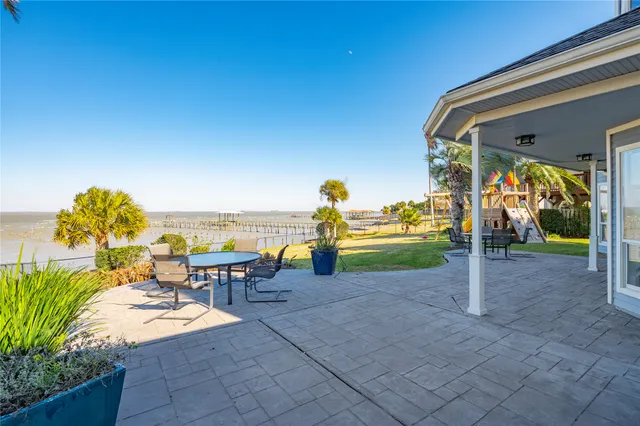 a view of a terrace with a table and chairs