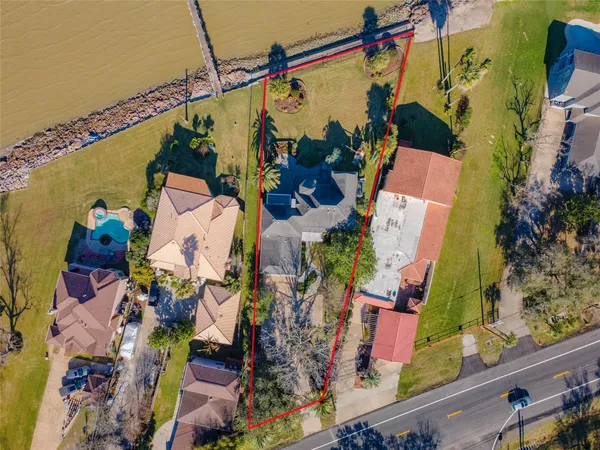 an aerial view of a house with a yard and fountain