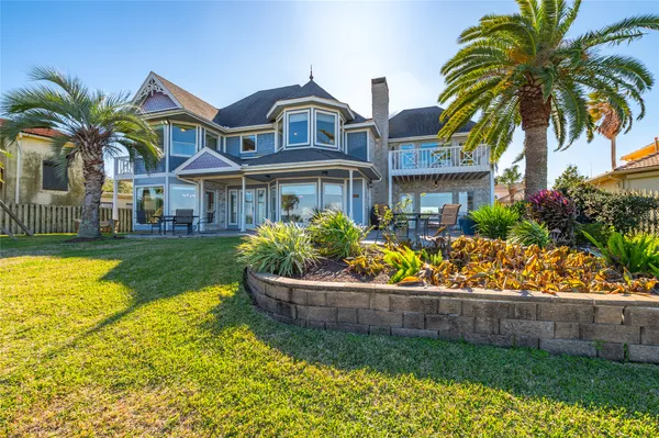 a front view of house and yard with swimming pool and green space