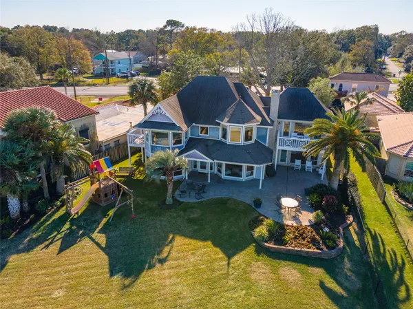 an aerial view of a house with swimming pool garden and mountain view