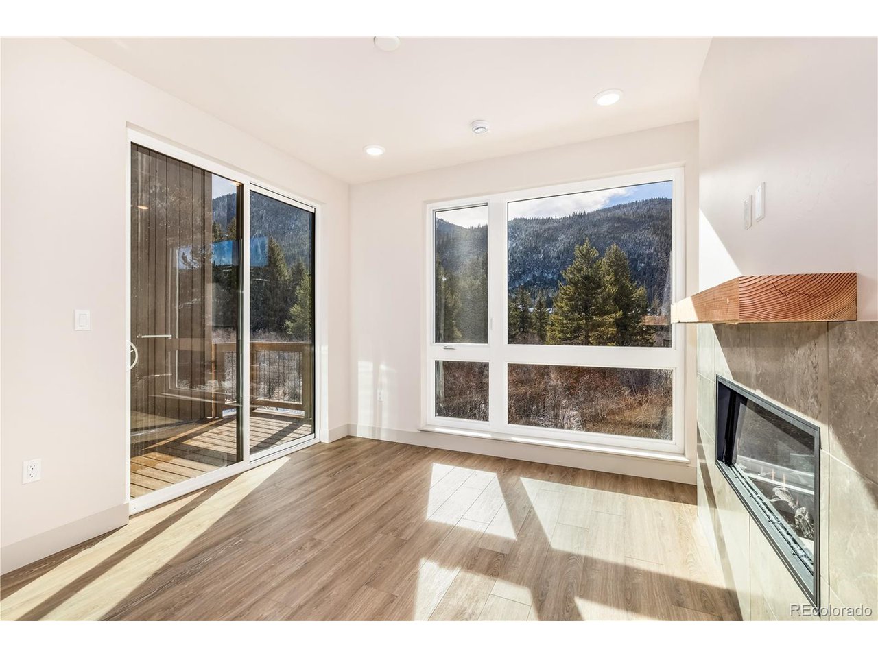 624 Montezuma Road, Unit D Keystone, CO 80435 - Photo 3 of 31 a view of an empty room with wooden floor and a window
