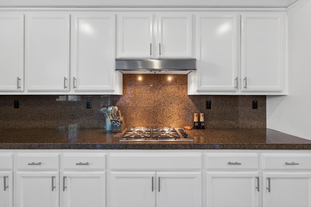 1820 Donner Road West Sacramento, CA 95691 - Photo 14 of 44 a kitchen with granite countertop white cabinets and a white stove