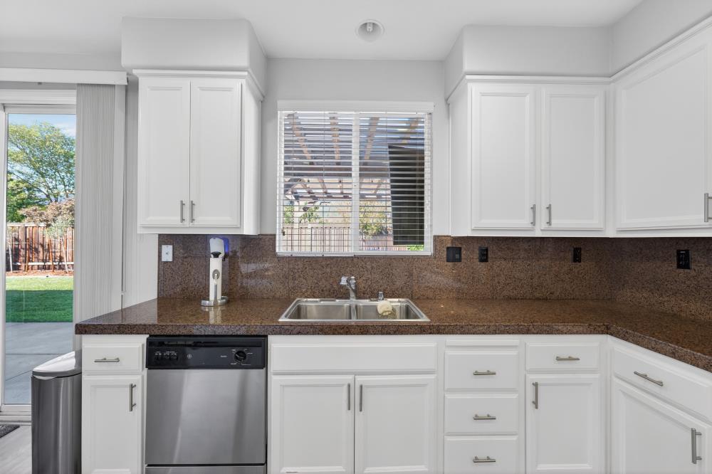 1820 Donner Road West Sacramento, CA 95691 - Photo 15 of 44 a kitchen with granite countertop white cabinets and sink