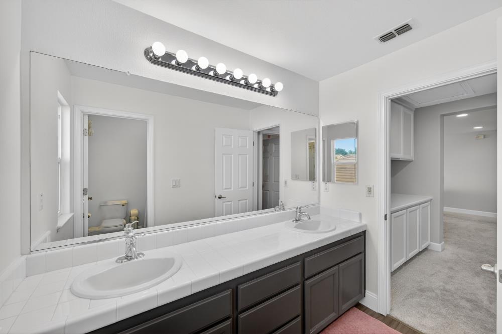 1820 Donner Road West Sacramento, CA 95691 - Photo 24 of 44 a bathroom with double vanity sinks and a mirror