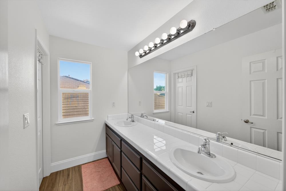 1820 Donner Road West Sacramento, CA 95691 - Photo 25 of 44 a bathroom with a double vanity sink and a mirror
