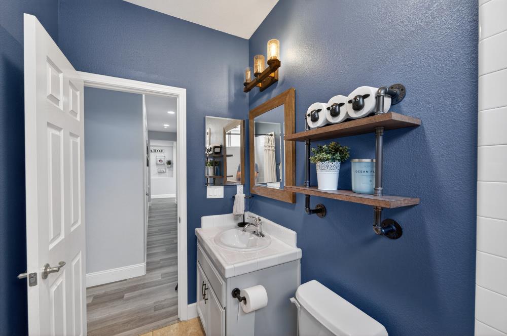 1820 Donner Road West Sacramento, CA 95691 - Photo 27 of 44 a bathroom with a sink mirror and toilet