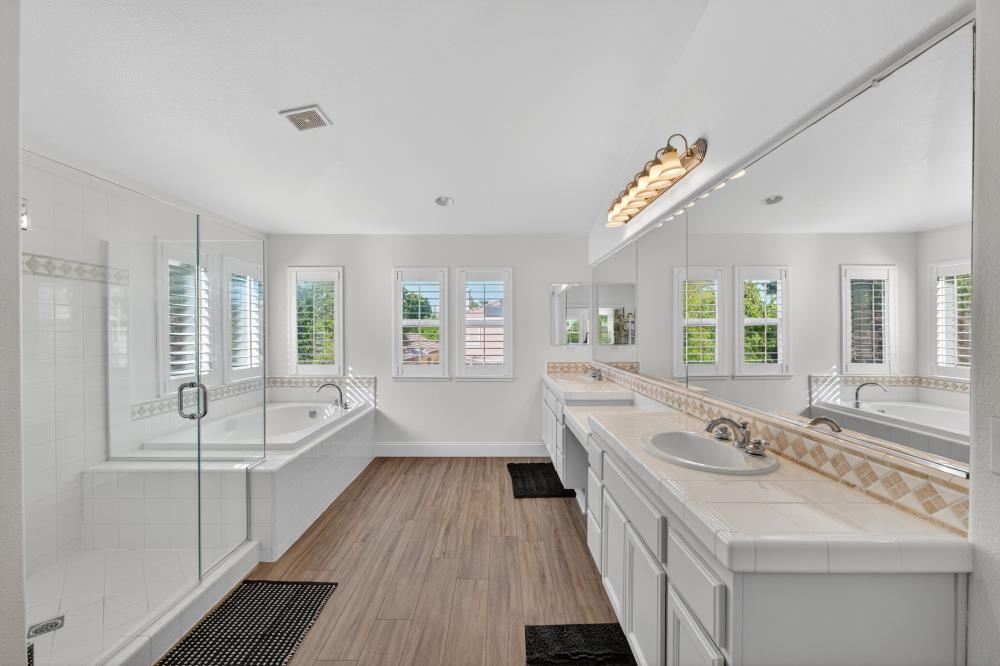 1820 Donner Road West Sacramento, CA 95691 - Photo 6 of 44 a bathroom with a double vanity sink a mirror and a bathtub