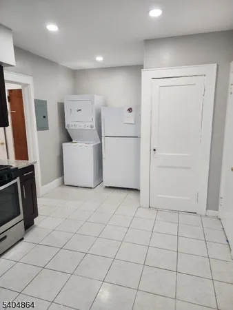 a view of kitchen with refrigerator and microwave