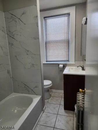 a bathroom with a sink a toilet and bathtub