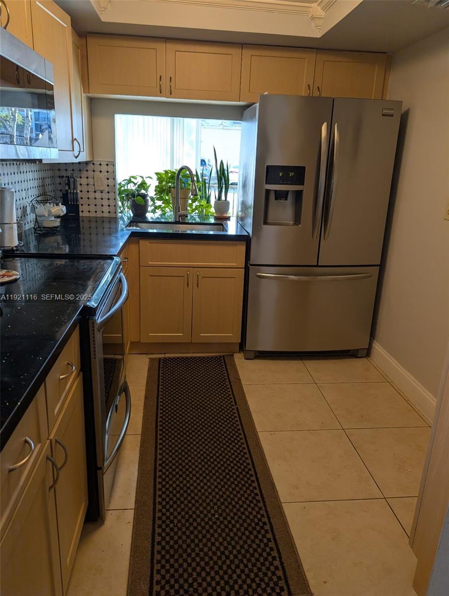 9401 Southwest 4th Street, Unit 110 Miami, FL 33174 - Photo 2 of 8 a kitchen with a refrigerator and a stove