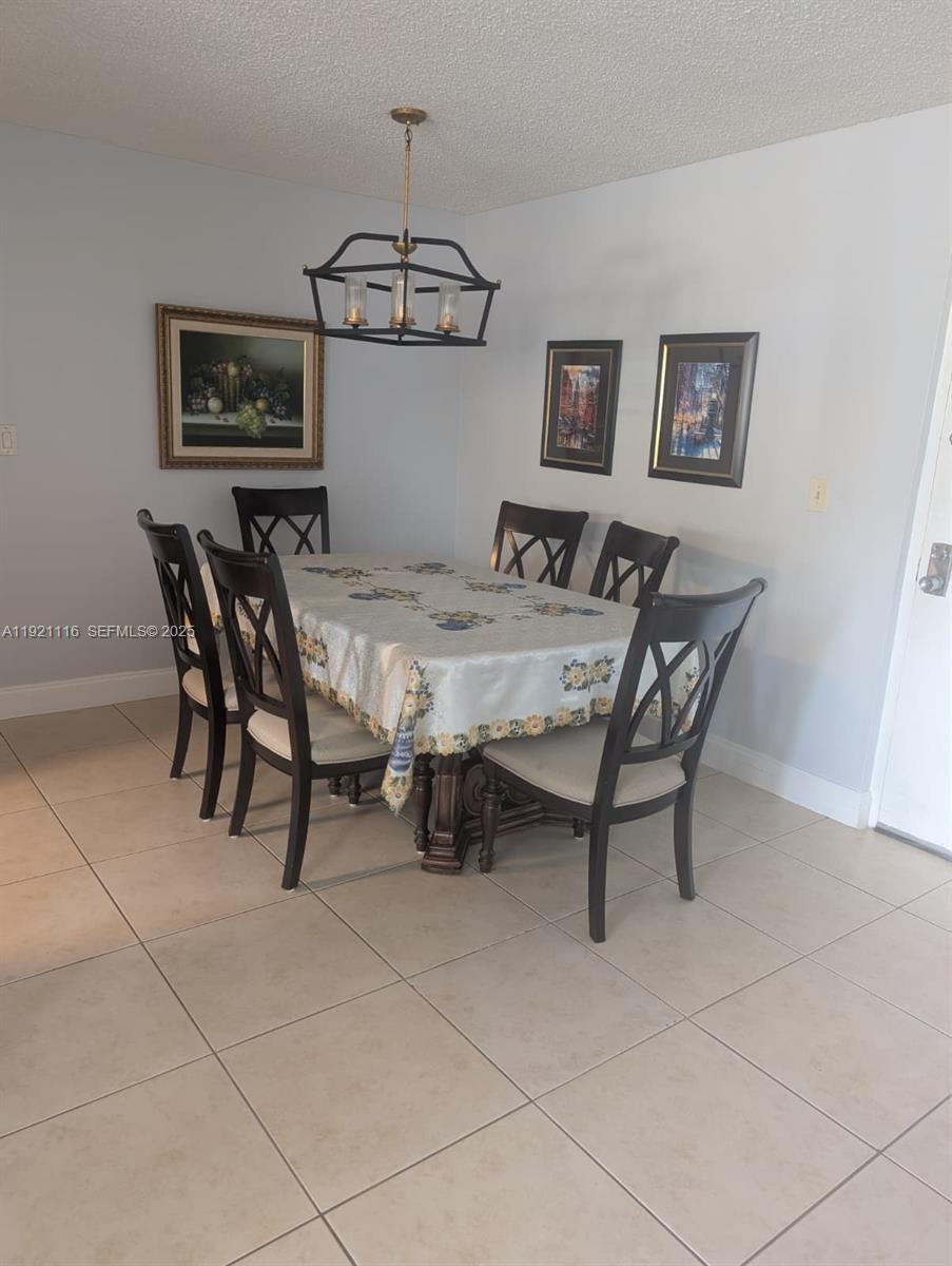 9401 Southwest 4th Street, Unit 110 Miami, FL 33174 - Photo 4 of 8 a view of a dining room with furniture