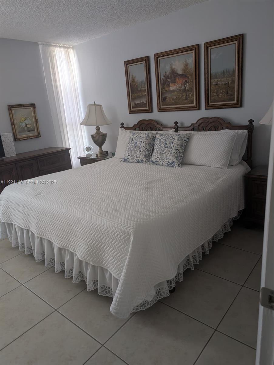 9401 Southwest 4th Street, Unit 110 Miami, FL 33174 - Photo 7 of 8 a bedroom with a bed and a couch