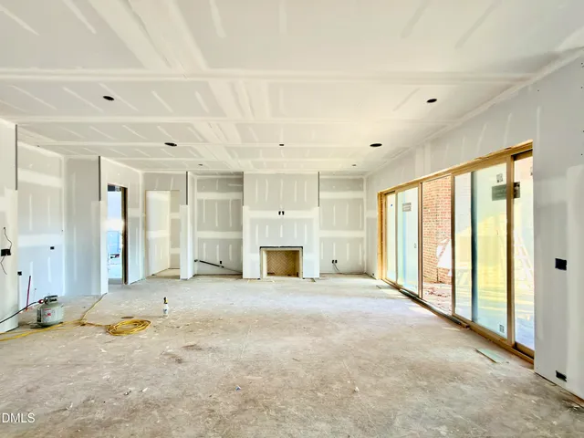 a living room with furniture fireplace and a large window