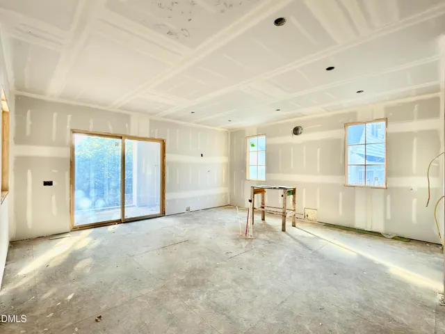 a kitchen with a stove a sink dishwasher a kitchen island with chairs and wooden cabinets