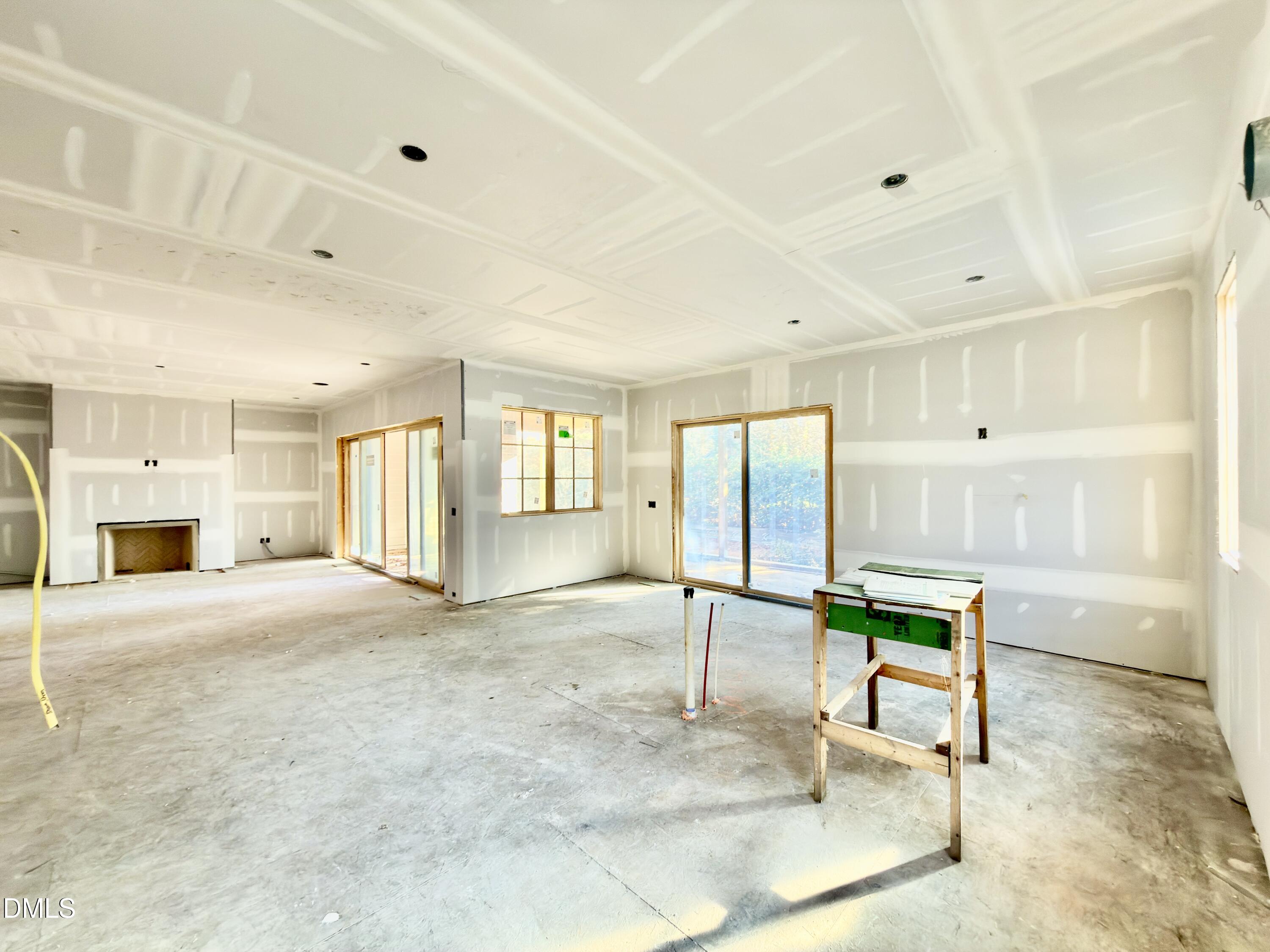 6832 Greystone Drive Raleigh, NC 27615 - Photo 23 of 51 a view of an empty room with a fireplace and a window