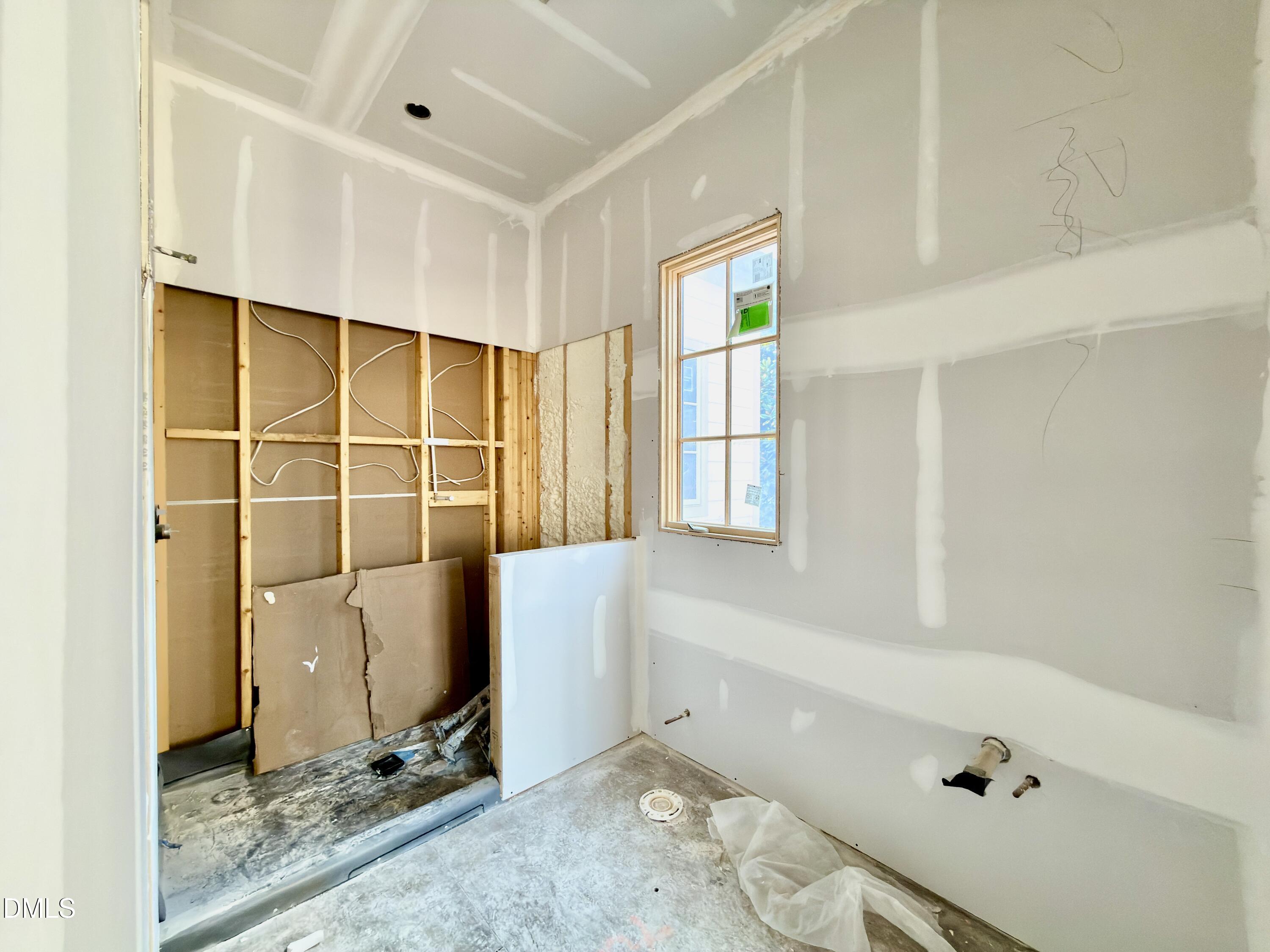6832 Greystone Drive Raleigh, NC 27615 - Photo 31 of 51 a bathroom with a tub and a window
