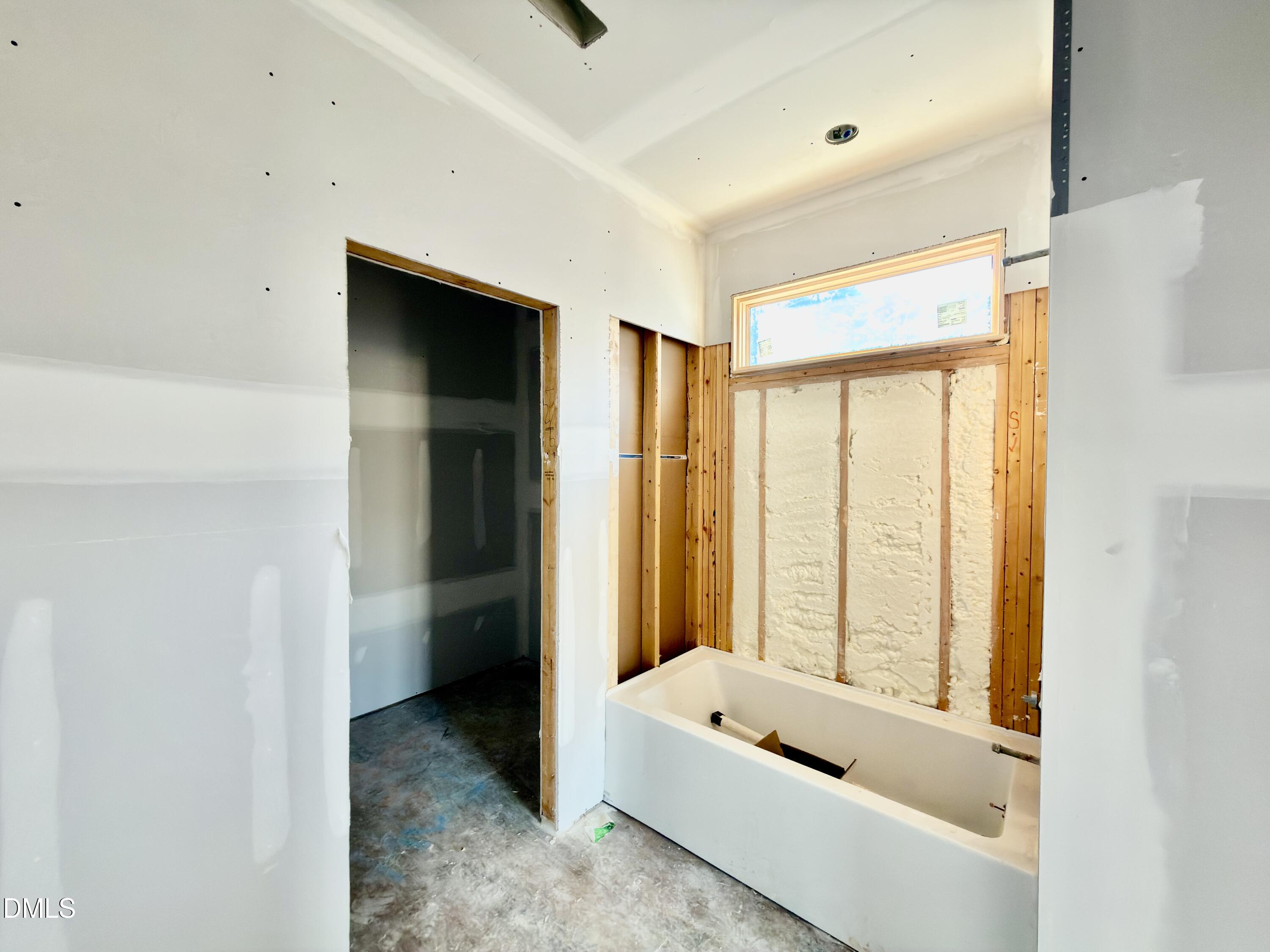 6832 Greystone Drive Raleigh, NC 27615 - Photo 43 of 51 a bathroom with a tub a window and a shower