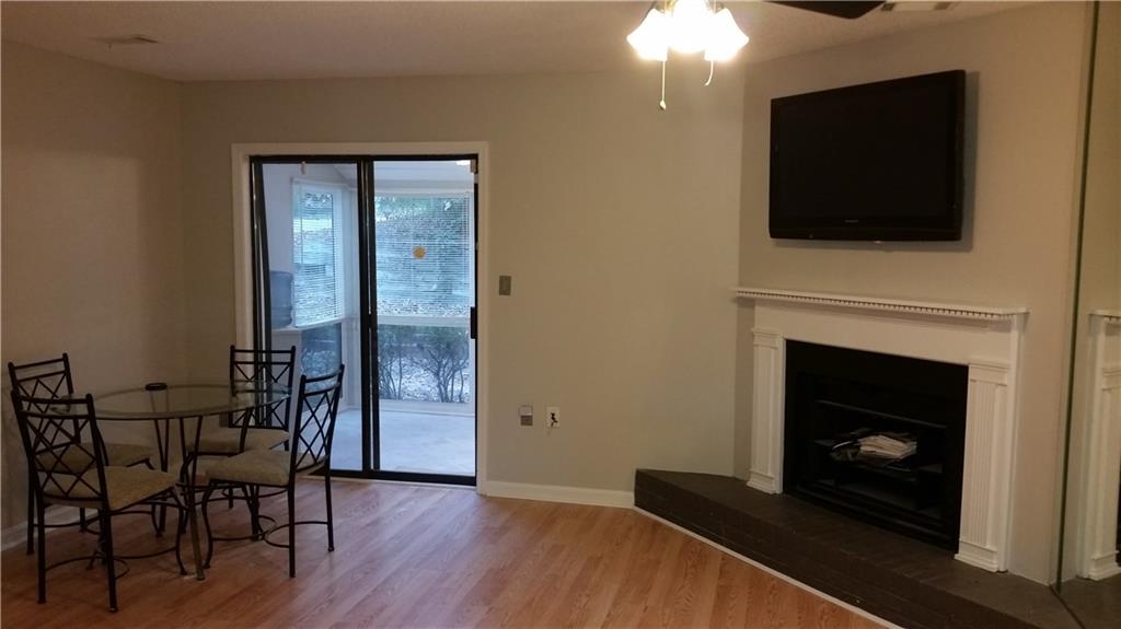 6053 WinterGreen Road Northwest Norcross, GA 30093 - Photo 1 of 1 Beautifully repainted living room with included flat screen TV overlooks enclosed private sunroom.