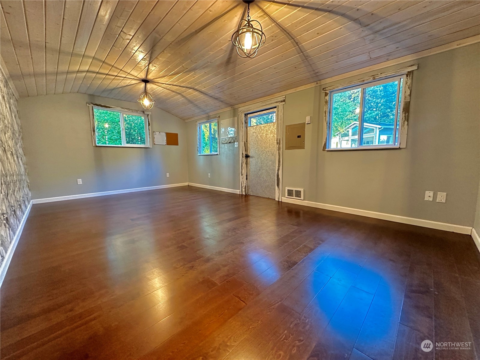 8307 Waddell Creek Road Southwest Olympia, WA 98512 - Photo 20 of 33 an empty room with wooden floor and windows