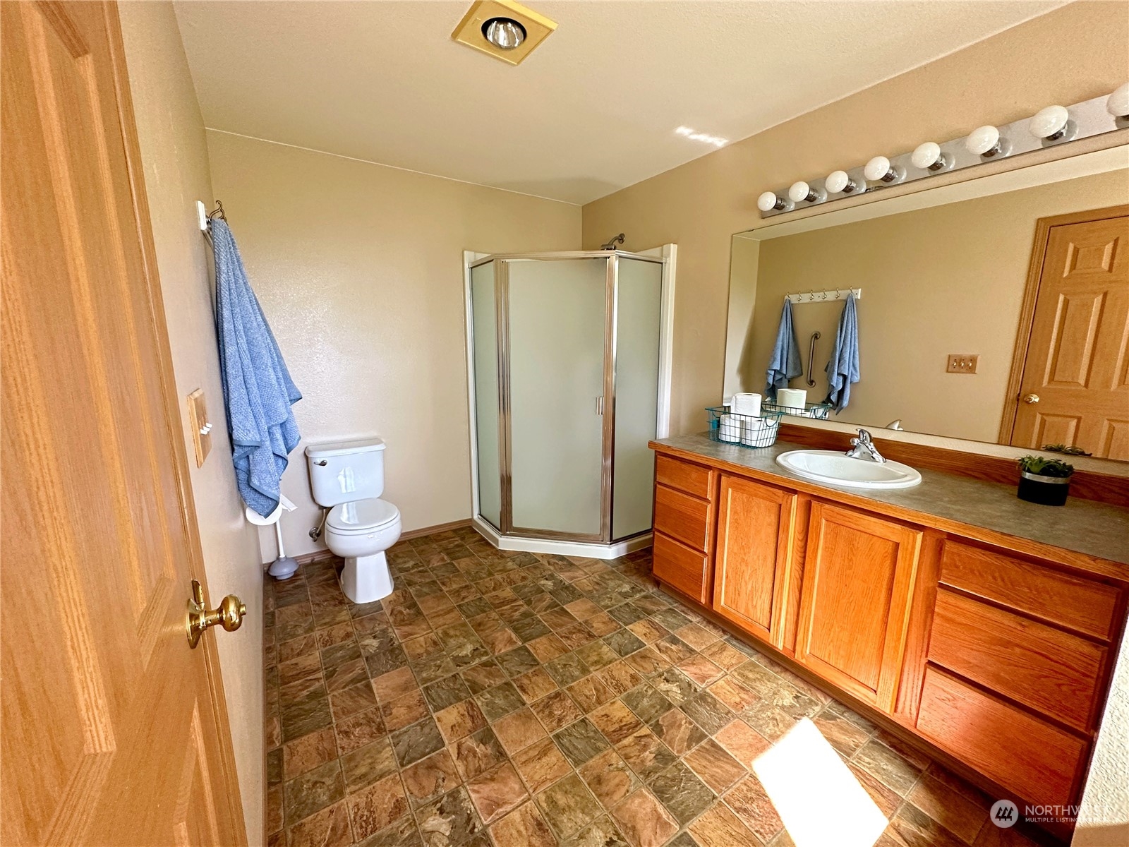 8307 Waddell Creek Road Southwest Olympia, WA 98512 - Photo 8 of 33 a bathroom with a sink a toilet and a mirror