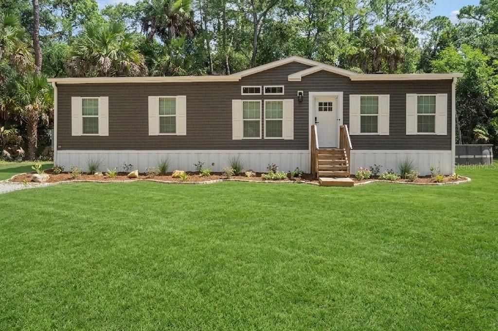 375 Sapp Street Inglis, FL 34449 - Photo 34 of 36 a front view of a house with a yard and trees