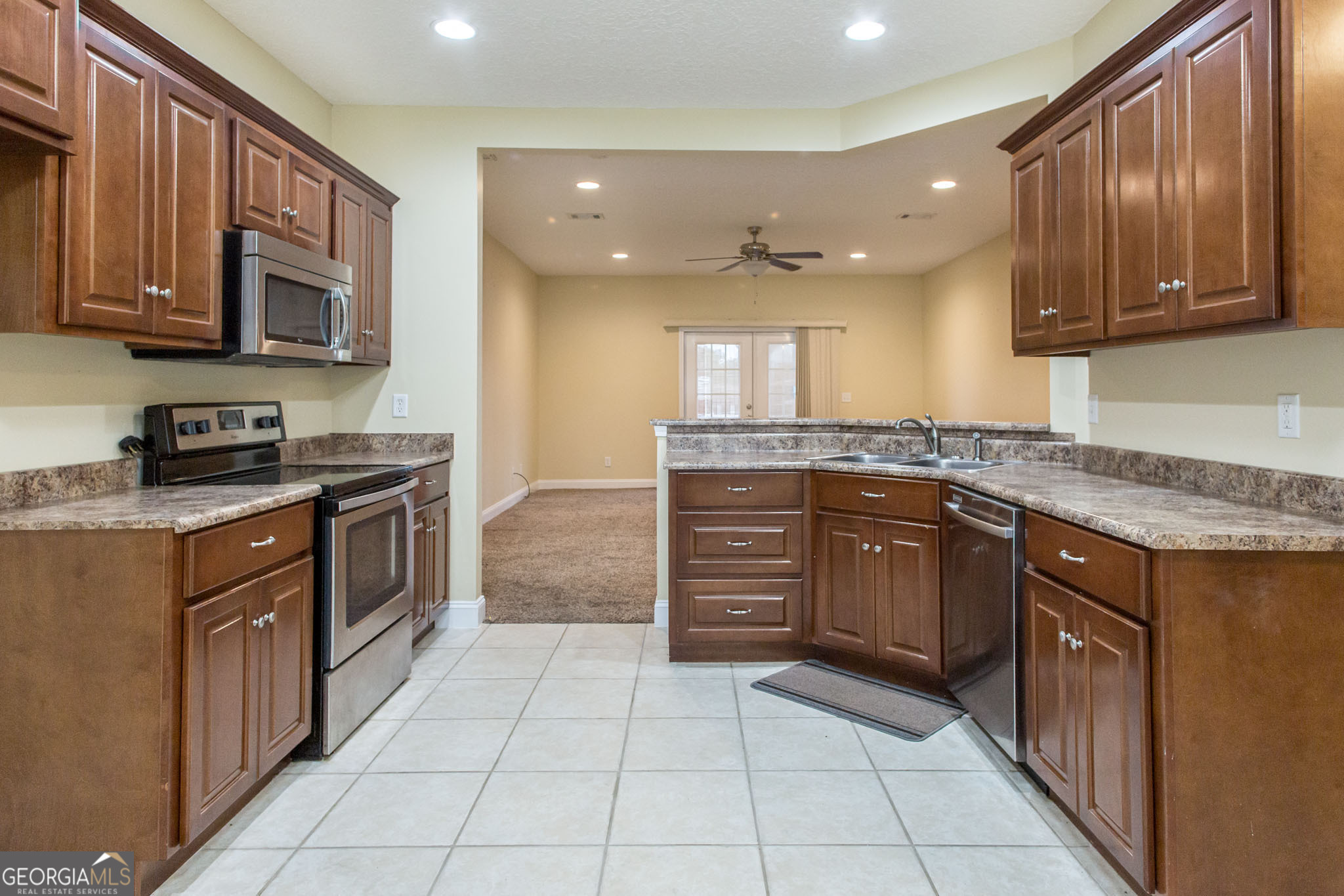 2869 Ben Street Waycross, GA 31503 - Photo 11 of 37 a kitchen with a stove top oven sink and cabinets