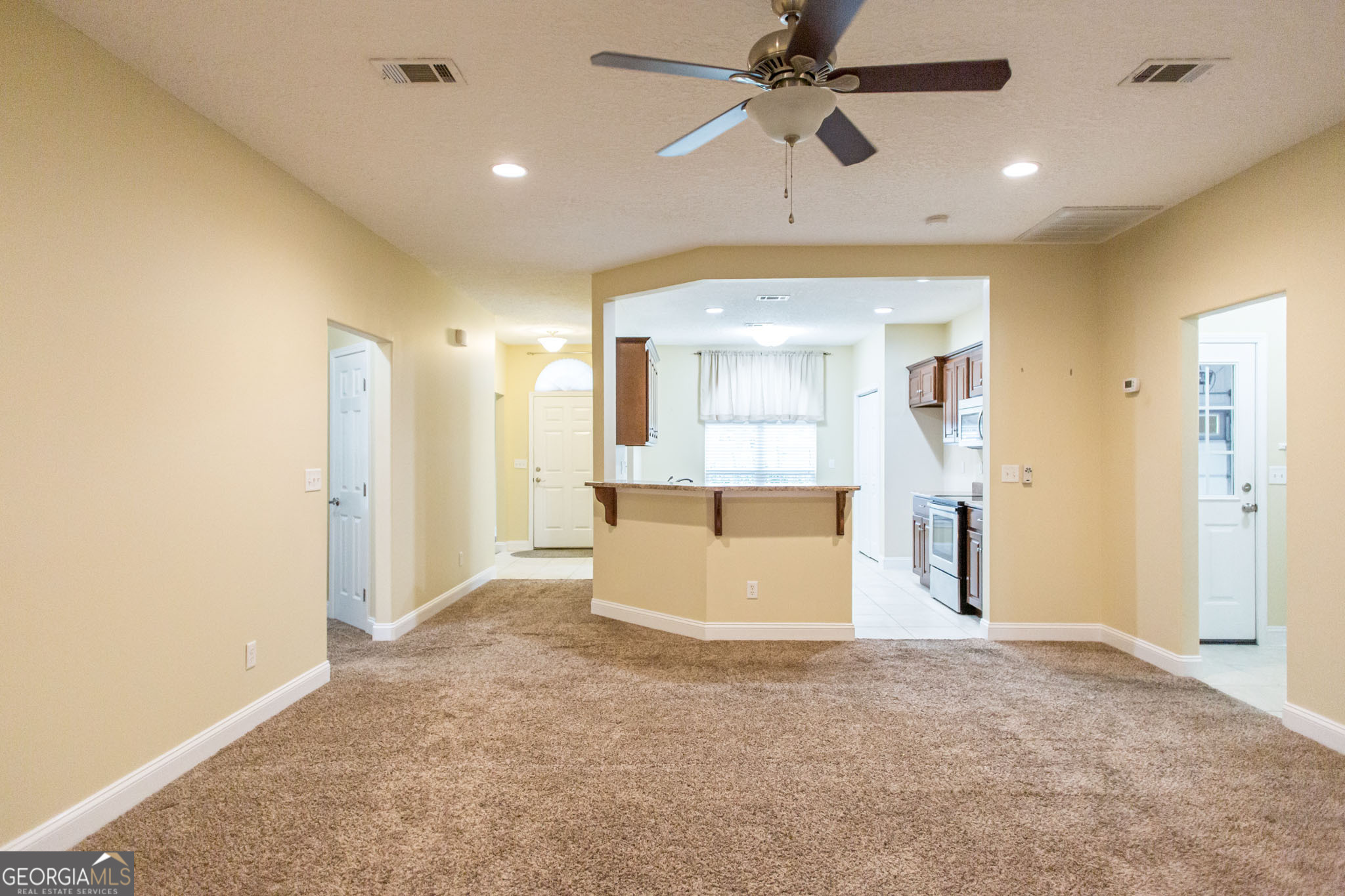 2869 Ben Street Waycross, GA 31503 - Photo 13 of 37 a view of empty room with wooden floor and fan