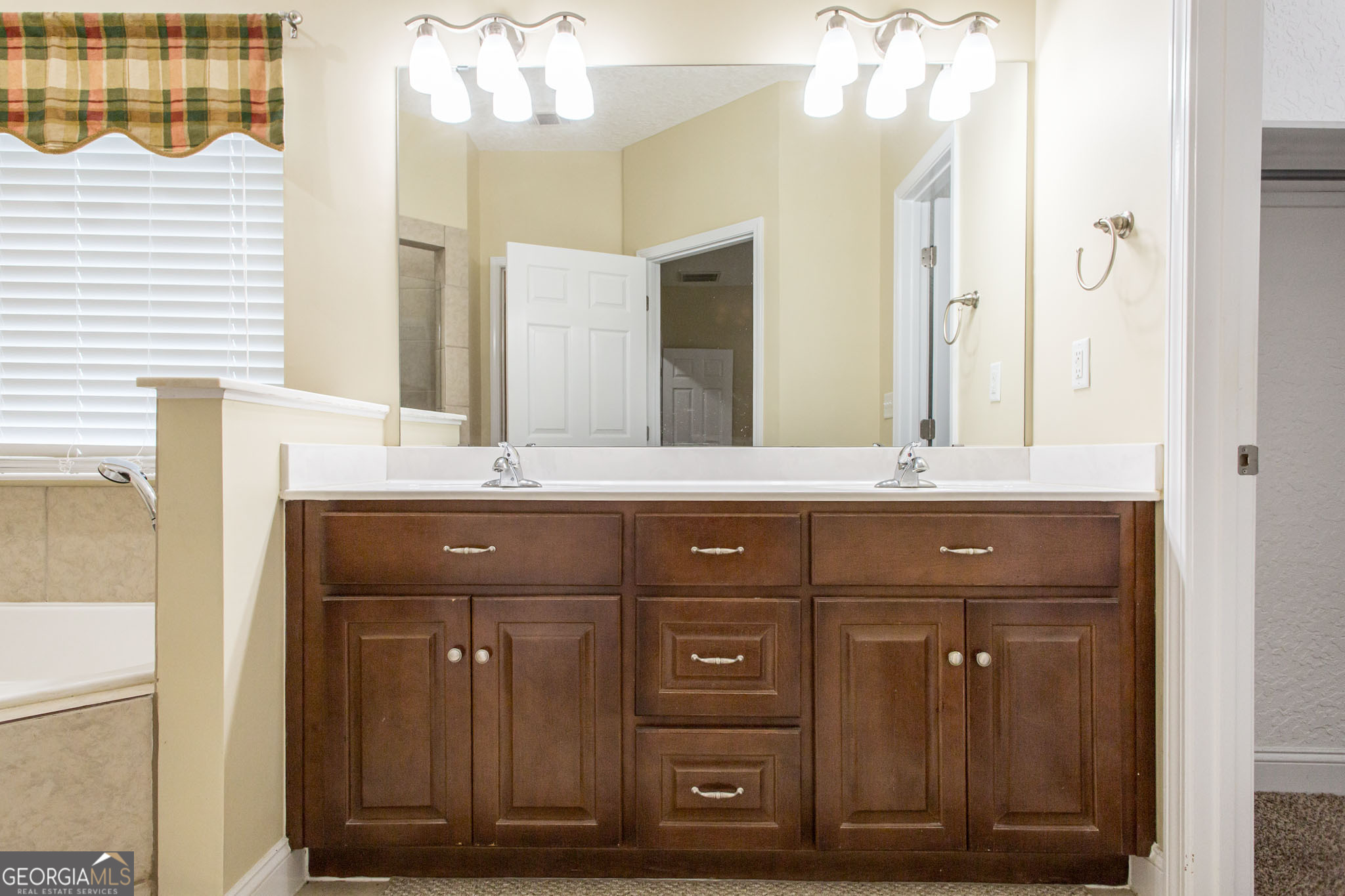 2869 Ben Street Waycross, GA 31503 - Photo 24 of 37 a bathroom with a sink vanity and a mirror