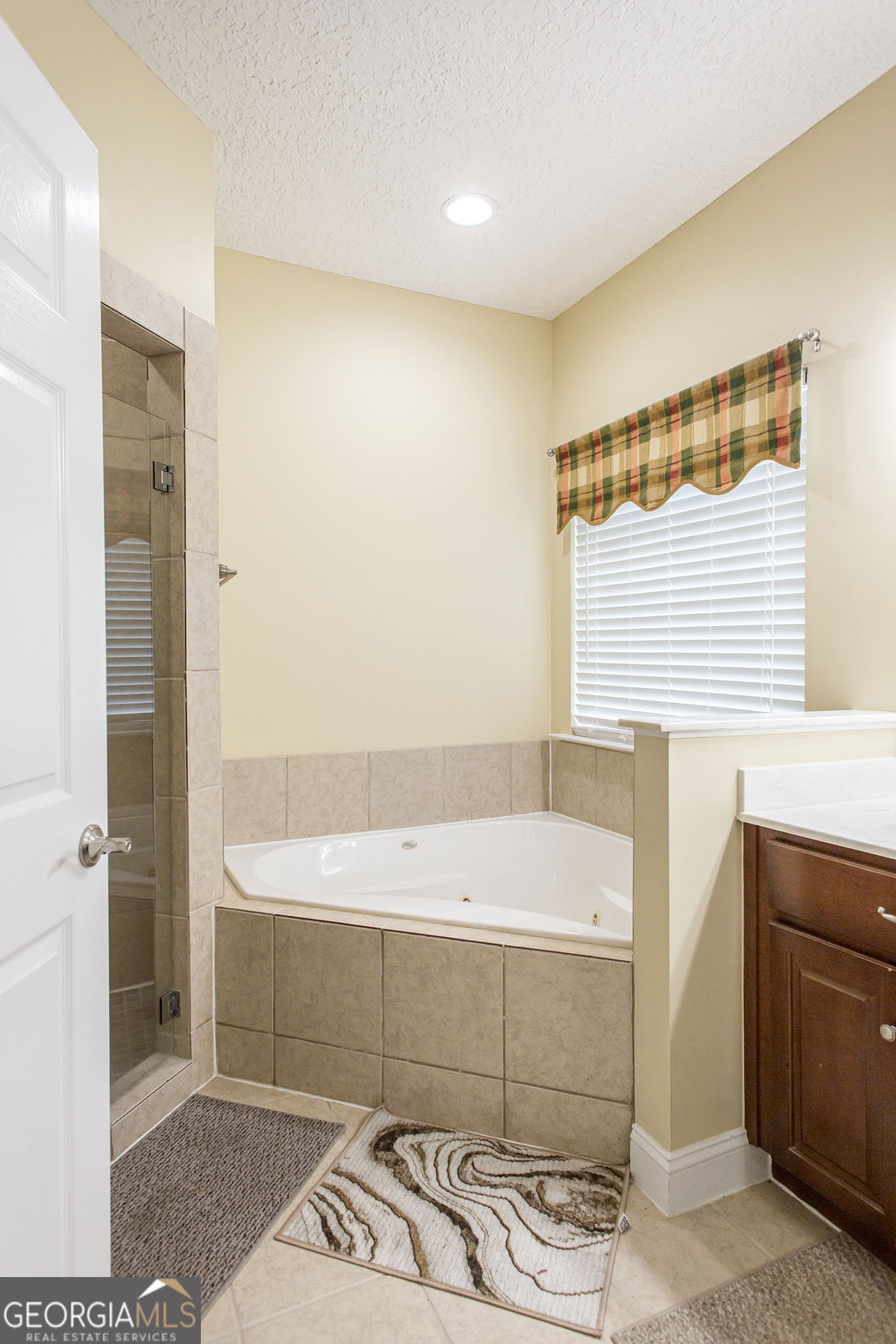 2869 Ben Street Waycross, GA 31503 - Photo 25 of 37 a bathroom with a bathtub a sink and a shower