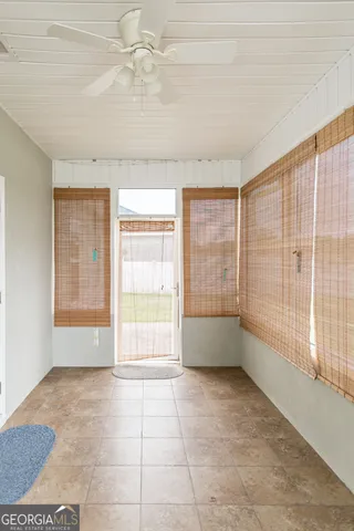 a view of a house with a yard and potted plants